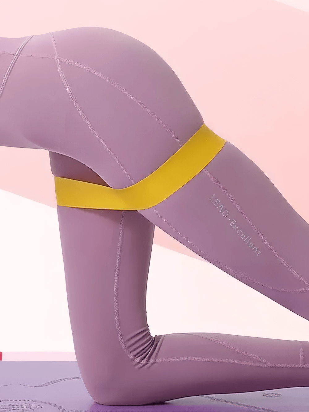 Person using yellow resistance band for Pilates squat exercise, demonstrating flexibility and strength training with fitness bands.